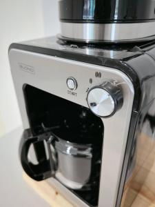 a coffeemaker with a coffee pot on top of it at 5 beds 452sqm with Private garden Pet-friendly CCTV quiet and homey in Sathani Ban Hua Mak