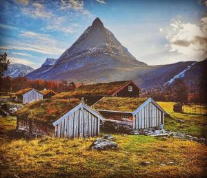 a painting of a farm with a mountain in the background at Modern apartment Sunndalsøra city center - Balcony in Sunndalsøra +16 photos