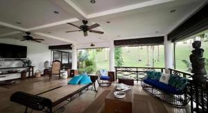 a living room with a couch and a ceiling fan at Ticao Altamar Boutique Resort in Tahiran