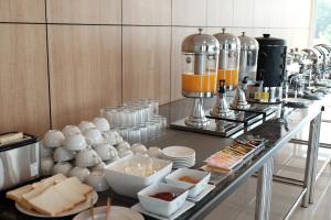 a buffet of food on a counter in a room at Chaisaeng Villa in Sing Buri +22 photos