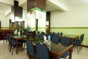 a dining room with tables and chairs in a room at OYO 381 Hotel Pashupati Plaza in Kathmandu