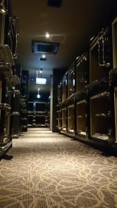 a dark room with a large room with empty boxing racks at Gran Customa Isezakicho in Yokohama