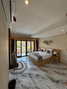 a bedroom with a large bed in a room at Mara inn in Nusa Dua