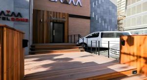 a building with a van parked in a parking lot at Some Motel in Suwon