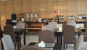 a dining room with a table and chairs at Chaisaeng Villa in Sing Buri