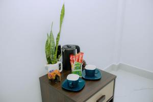 a table with two plates and cups on it at Seya Villa in Kekirawa