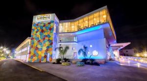 a large white building with a building with a painting on it at Nicholas Color Hotel in Ayia Napa