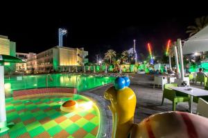 a swimming pool at night with a toy in the middle at Nicholas Color Hotel in Ayia Napa