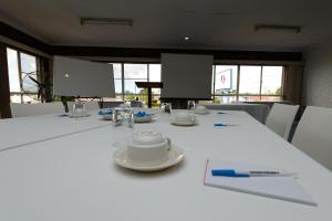 a white table topped with a white table cloth at Smart Motels Bert Hinkler in Bundaberg
