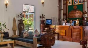two people standing in a store with a counter at Sambopich Chenla Hotel in Kompong Thom +222 photos