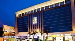a building with a sign on the side of it at Grand Hawaii Hotel Pekanbaru in Pekanbaru