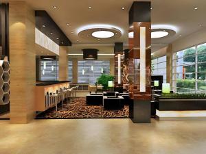 a lobby of a hotel with a bar and chairs at Asoka Luxury Hotel in Bandar Lampung