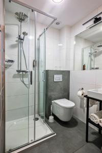 a bathroom with a shower and a toilet and a sink at Hotel Pietrak in Wągrowiec +64 photos