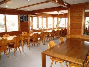 a dining room with wooden tables and chairs at ペンション木いちご PensionKiichigo in Zaō Onsen +14 photos