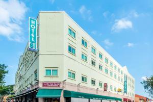 a white building with a sign on the side of it at Hotel 81 Tristar in Singapore