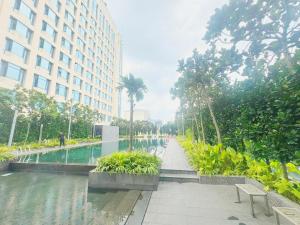 a walkway next to a pool in a building at Opus Residences by Ardent Homes in Kuala Lumpur