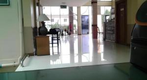 a room with a hallway with a table and chairs at Amarin Grand Hotel in Rayong +52 photos