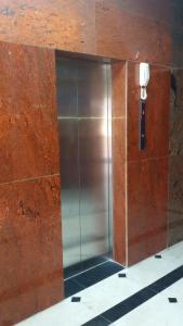 a elevator with a metal door in a building at Serapis Hotel in Ḩilf