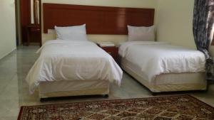 Postelja oz. postelje v sobi nastanitve Serapis Hotel