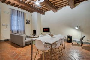 Una sala de estar con una mesa y sillas blancas. en Borgo di Libbiano - for exploring all of Tuscany, en Libbiano