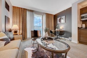 a living room with a couch and a table at Aura Studio at MGM Signature FREE Valet Parking in Las Vegas
