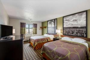 a hotel room with two beds and a flat screen tv at Super 8 By Wyndham Wayne in Wayne