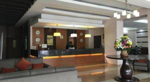 a lobby of a hotel with a reception desk at Baguio Burnham Suites Hotel in Baguio