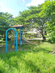 a playground with a slide in a park at Z Crib Solana in Bacolor