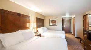 a hotel room with two beds and a television at White Peak Hotel – Frisco By IHG in Summit Medical Center Heliport +7 photos