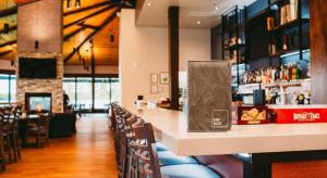 a bar in a restaurant with tables and chairs at Best Western Lake Lucille Inn in Wasilla