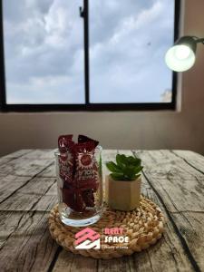 a table with a glass jar and a plant on it at Rent Space Coliving Bandar Hilir Melaka in Melaka +5 photos