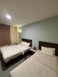 Postel nebo postele na pokoji v ubytování Peridonne Hotel