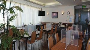 a dining room with tables and chairs and a television at Pearl Hotel Ota in Isesaki +84 photos