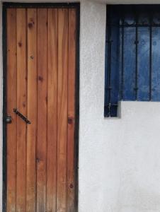 a wooden door on the side of a building at Xaltepic tú casa in Amecameca de Juárez +2 photos