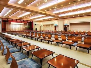a lecture hall with rows of desks and chairs at Shodoshima International Hotel in Tonosho +196 photos