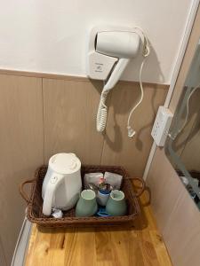 a hair dryer and cups in a basket in a room at Seasmile kohlarn in Ko Larn +29 photos