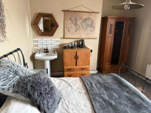 a bedroom with a bed and a sink and a mirror at Boars Head in Louth +23 photos