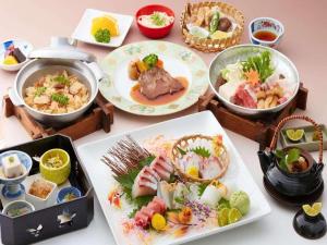 a table topped with plates of food and bowls of food at Ako Royal Hotel in Himeji +81 photos