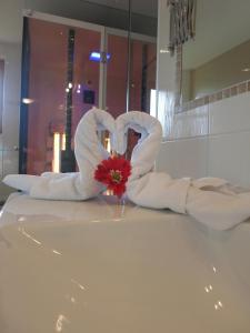 two towels in the shape of a heart on a bathroom counter at Haus Panorama in Schladming