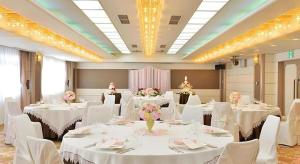 a banquet room with white tables and white chairs at Hotel Ligare Kasugano in Nara
