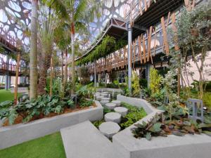 a courtyard with plants and trees in a building at Antara Genting Luxurious Hillside Suite Near SkyAvenue Mall in Genting Highlands