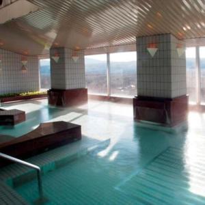 a swimming pool with blue water in a building at Villa Kitakaruizawa L-Wing in Tsumagoi