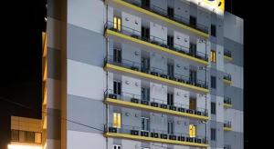 a tall building with balconies on the side of it at Super Hotel Satsuma Sendai in Satsumasendai