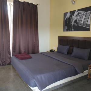 a bedroom with a large bed with purple sheets and a window at casa titos in Jāmb