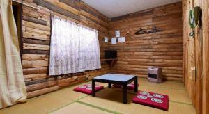 a room with a table in a log cabin at Sports Plaza Shirakaba in Tokamachi