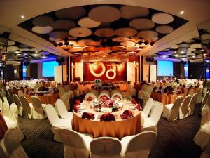 a banquet hall with white chairs and tables in a room at Tanahmas The Sibu Hotel in Sibu +71 photos