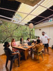 a group of people sitting around a table in a room at Odd Table Stay and Experiences in Mandrem