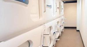 a row of white toilets in a room at SPOT ON 89726 Capsule Inn in Kota Kinabalu