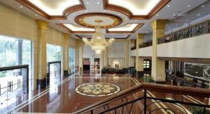 a large lobby with a chandelier and a large building at Gladden Hotel Shilong in Dongguan +250 photos