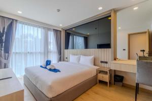a bedroom with a bed with a teddy bear on it at C240 New Prime Location 1BR Condo Near Beach Club in Thalang +27 photos